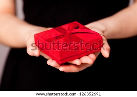 Red gift in hands.