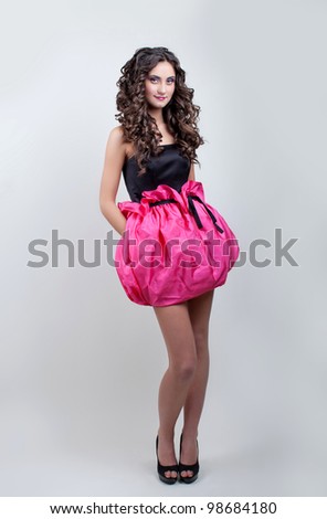 young model in pink mini skirt and black corset posing