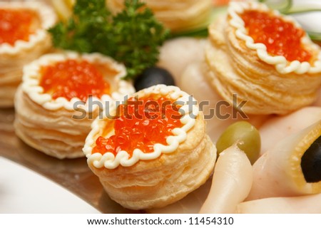 Backed rolls with red caviar, lemon and salmon
