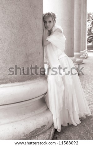 Bride near columns of an opera theater, summer, Siberia