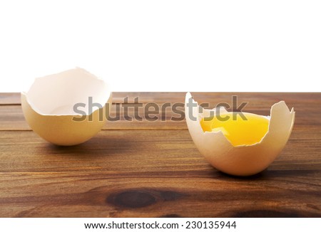 Broken egg on a wooden background