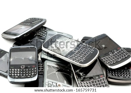stack of broken mobile phones