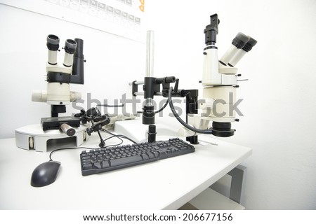 laboratory equipment, two microscopes on a desk