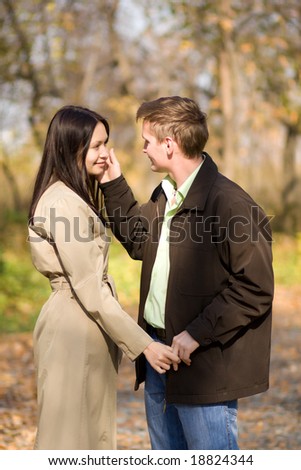 Young couple in love meeting in the autumn park