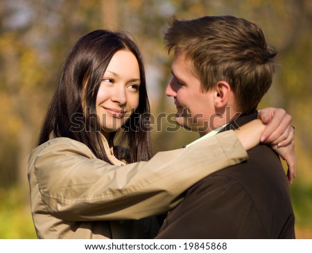 Young couple in love meeting in the autumn park
