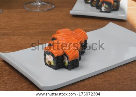 Close image of black sushi on table