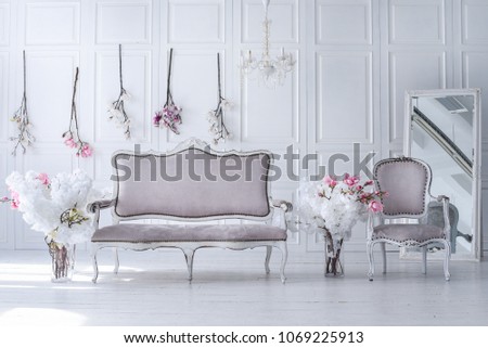 Interior of the living room in Victorian style with a vintage sofa and a vase with flowers