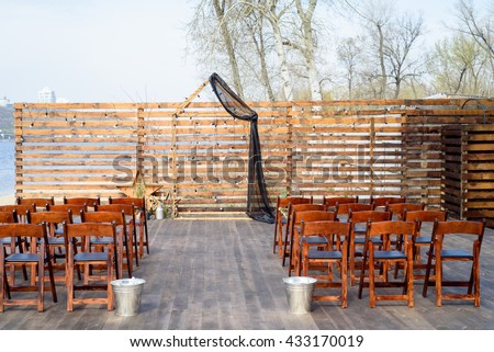 The scenery for wedding outside registration including wood chairs.