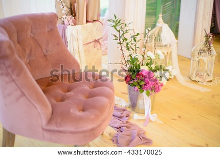 The scenery for wedding composed of flowers and beautiful red armchair.