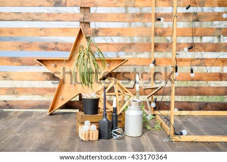 The scenery for wedding composed of plant, wood, lamps and decorative star.