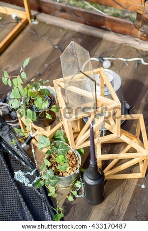 The scenery for wedding composed of plant, wood, lamps and decorative cubes.