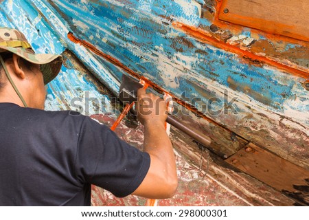 craftsman repair a boat by axe hand motion blur