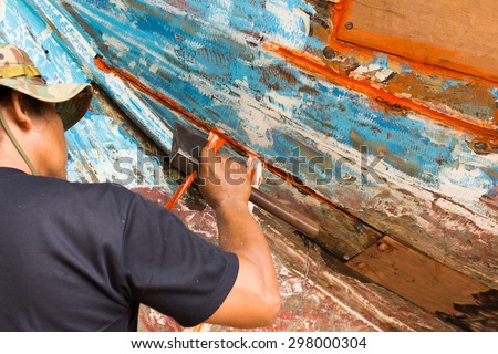 craftsman repair a boat by axe hand motion blur