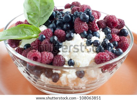 Cottage cheese in a clear bowl with summer berries