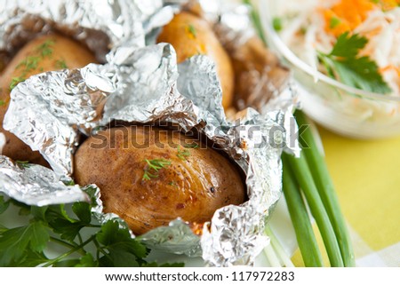 Jacket potatoes cooked in foil, and greens