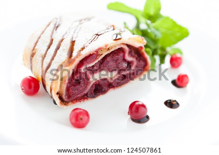 berry pie with cherries and cranberries on a white dish, close up