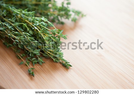 bunch of green thyme on a wooden surface, herbs closeup
