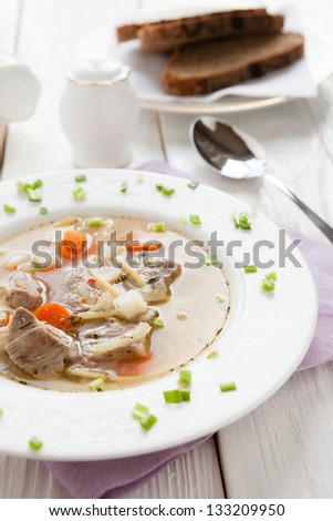 soup with chunks of beef and noodles, closeup