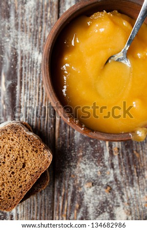 Rye bread and buckwheat honey in a ceramic bowl, top view