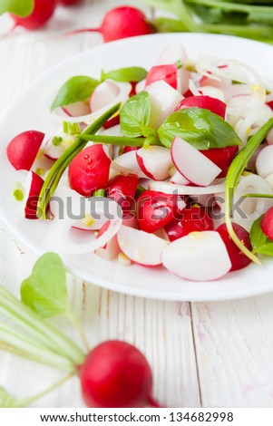salad of fresh radishes on a white plate, food