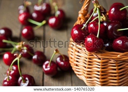 Ripe cherries in wicker basket basket, food close up