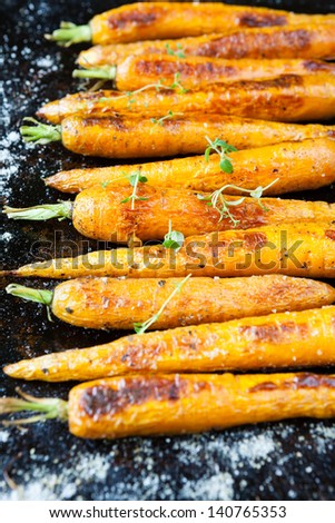 whole baked carrots with tails, food close up