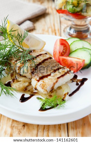 roast fillet lemon sole with onion and vegetables, food close up