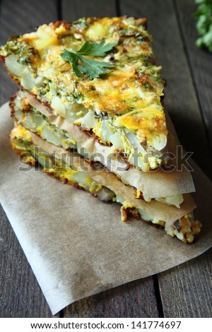 Spanish tortilla with slices of fresh greens, food