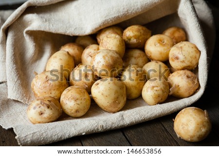 new potatoes with the peel on the table in a bag, food close up