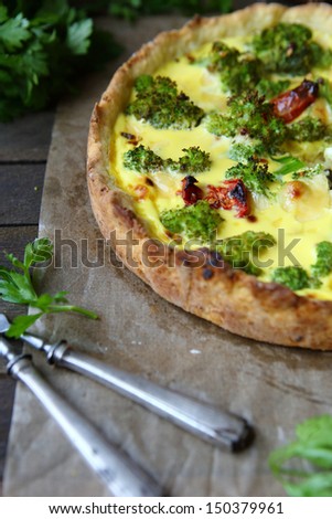 rustic pie with broccoli and sun-dried tomatoes, quiche, close up