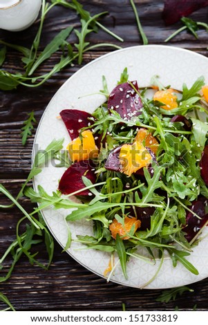 fresh salad with arugula, orange and beetroot, close up