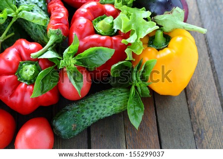 harvest of fresh vegetables on the table, pepper, tomato, basil, cucumber, tomato