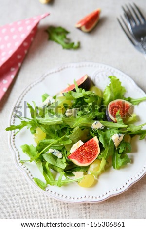 fresh salad with cheese, rocket salad and grapes, top view