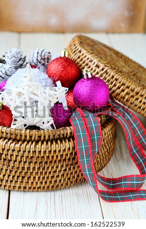 Background with Christmas decorations in a round wicker basket, decor