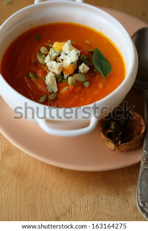 rustic pumpkin soup with cheese, food closeup