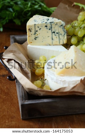 assortment of cheese on a tray, food closeup