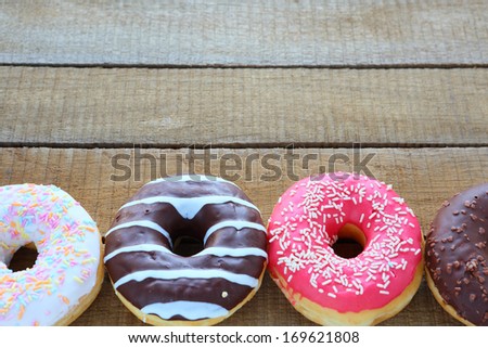 round donuts with colored glaze, food closeup