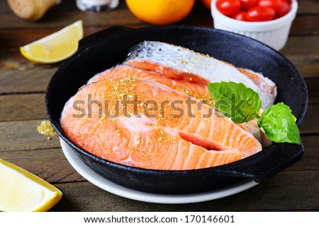 raw salmon fish fillets in the pan, food closeup