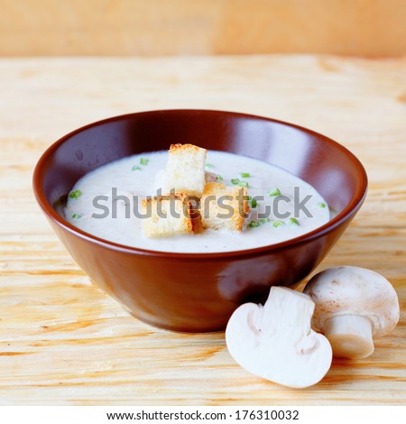 light mushroom soup in a bowl, food closeup