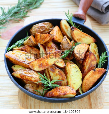 golden potato wedges with rosemary, food closeup