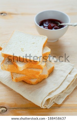 stack of white bread and jam in a bowl, food closeup