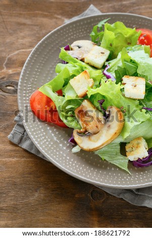 appetizing salad with croutons and mushrooms, food closeup