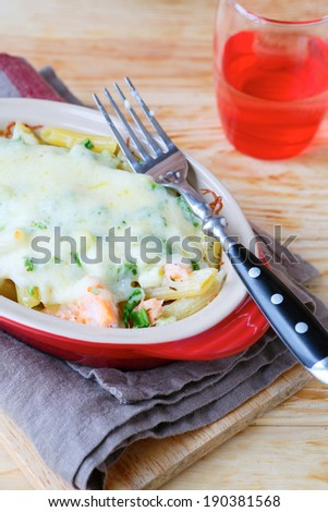 baked pasta with spinach and salmon, food closeup