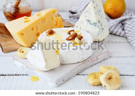 cheese platter with golden honey, food closeup
