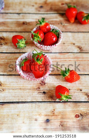 ripe strawberries in paper muffin dish, food closeup