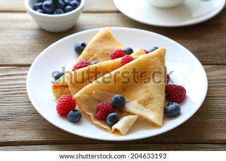 crepes with raspberries, blueberries, food closeup