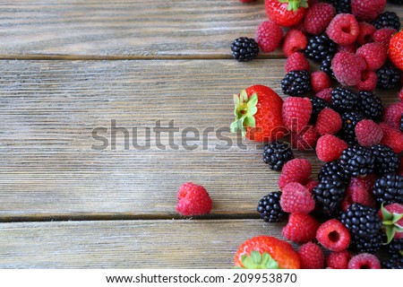 Summer berries on wooden background food closeup