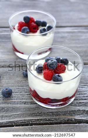 two glasses of yogurt with berries, food closeup