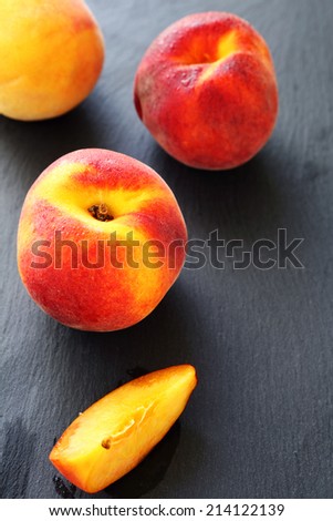 Juicy peaches on a gray  background, fresh fruit