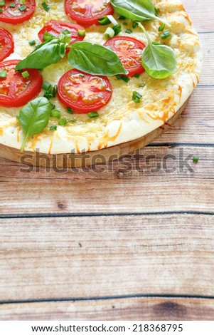 Tasty pizza with tomato, side view